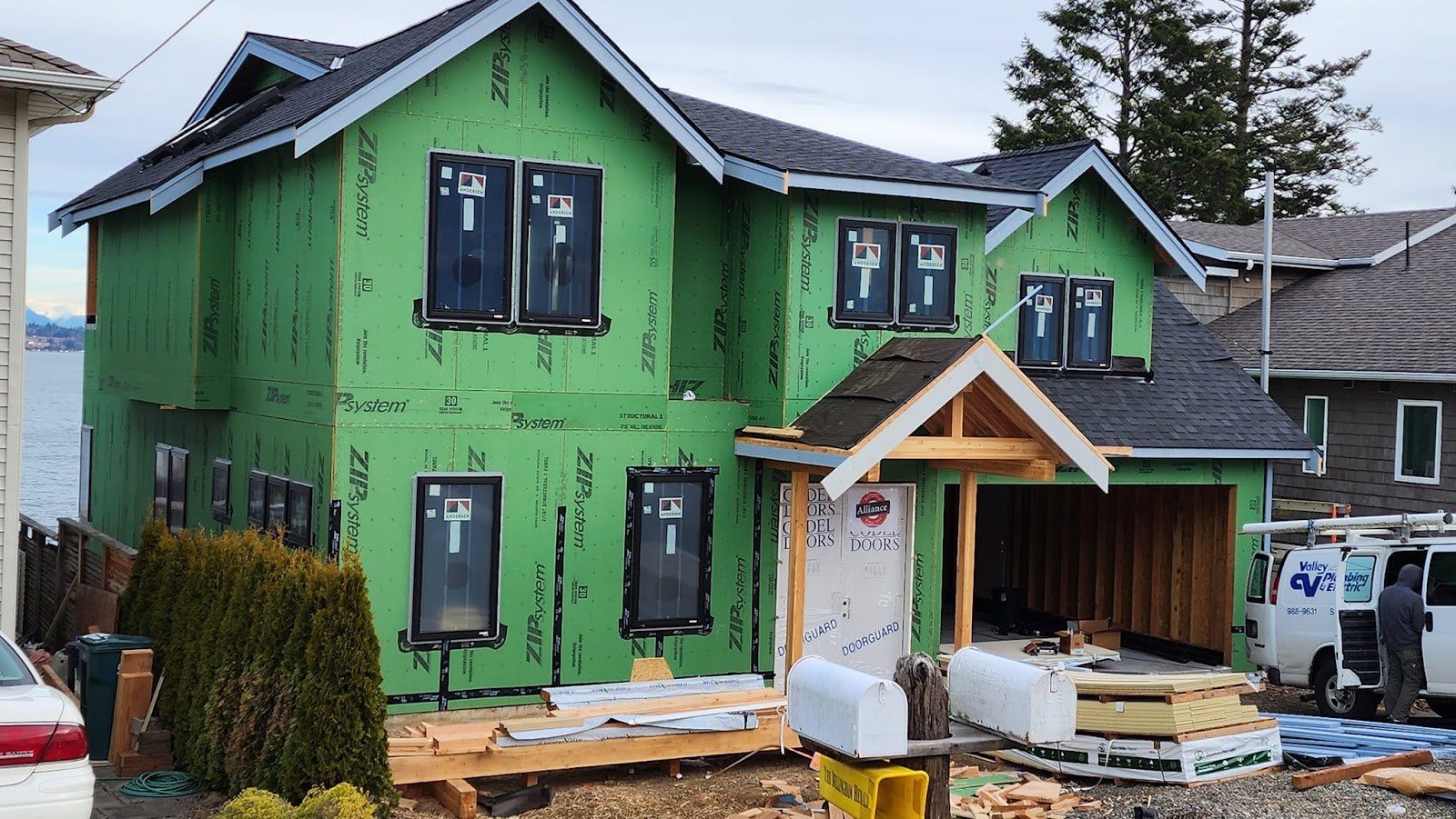 Two-story house wrapped and windowed during construction