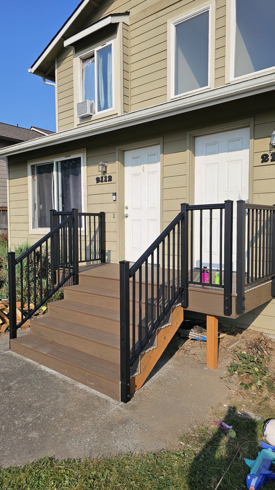 New front entry steps with black metal railing